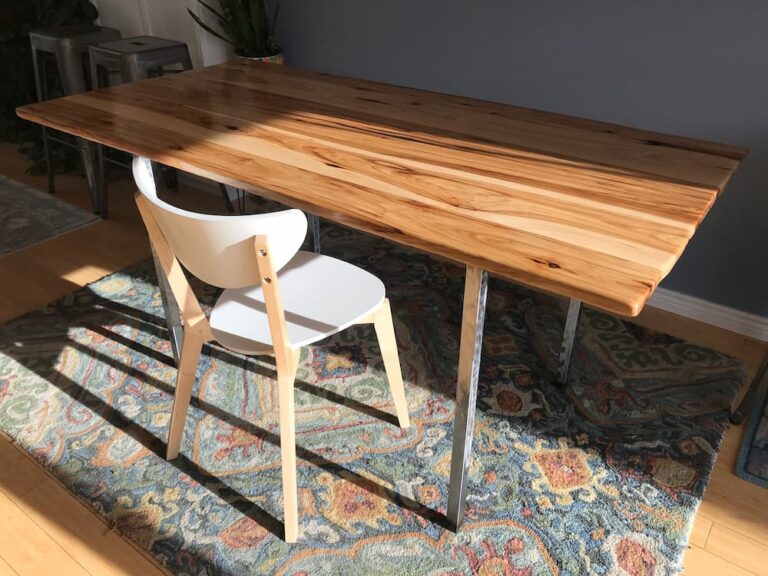 Table with wooden top and metal legs.