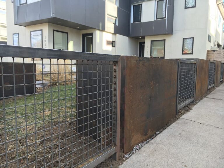 Fence made from steel boxes and mesh panels.