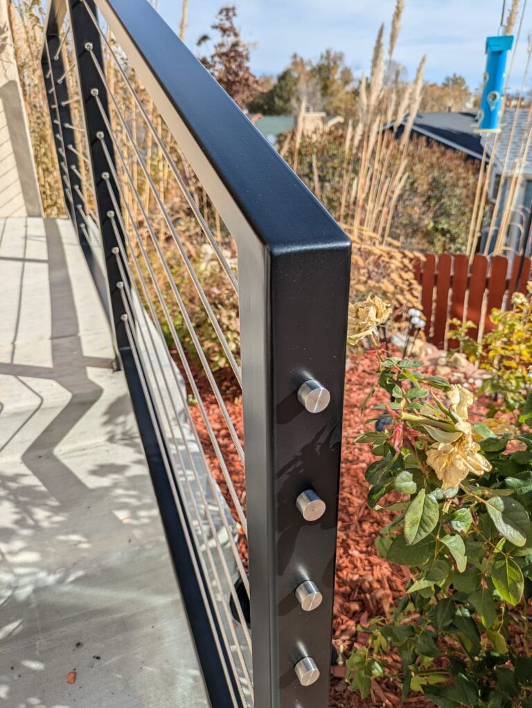 Closeup of railing with stainless steel cable infill.